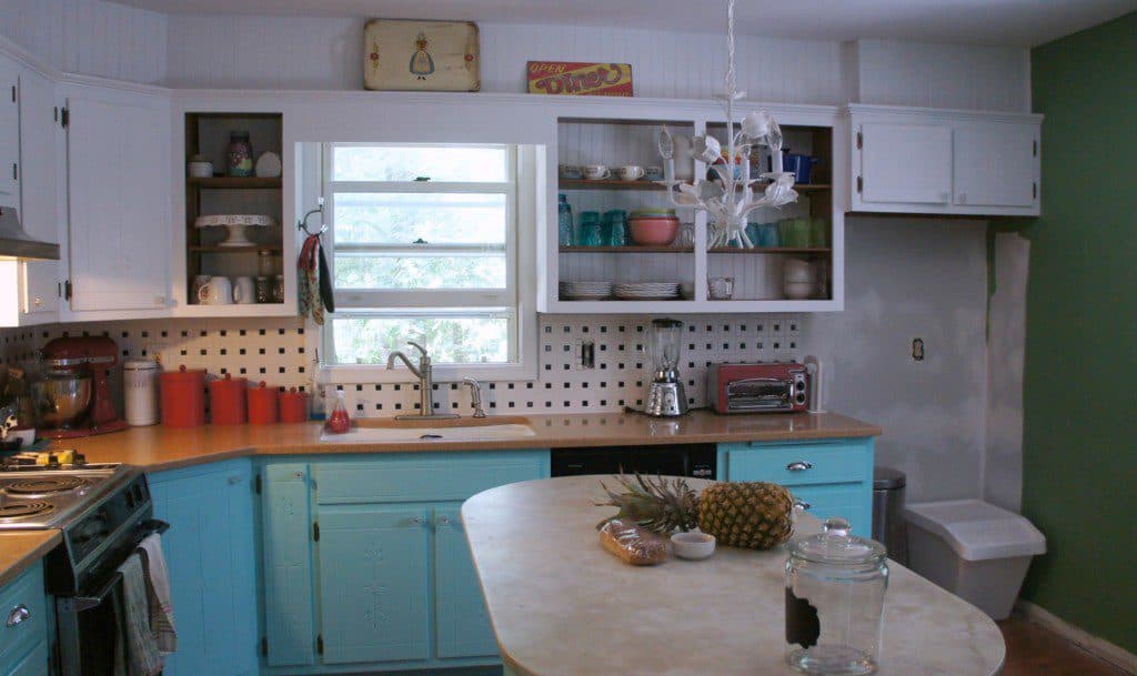 aqua kitchen cabinets and black and white tile backsplash