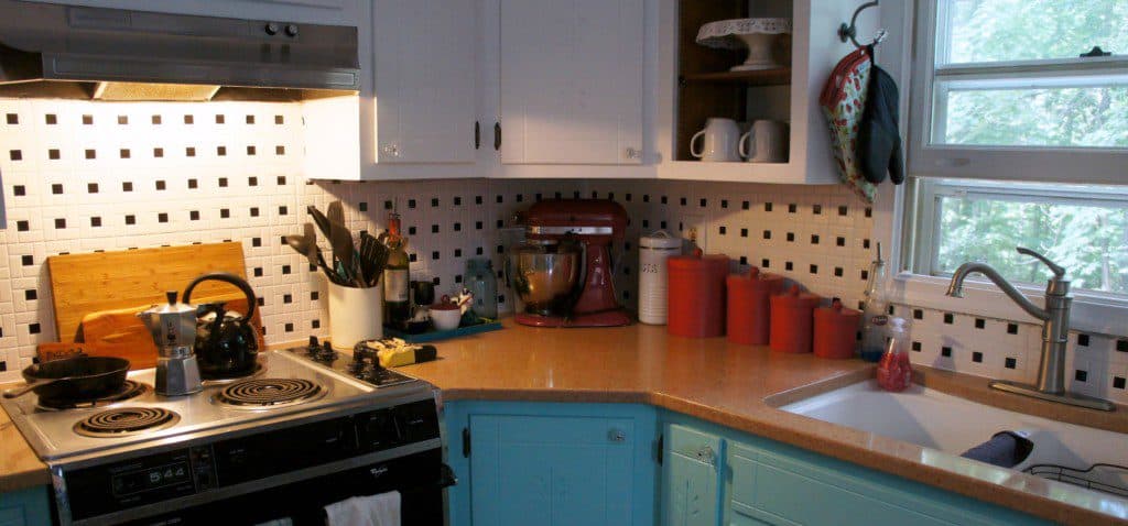 kitchen with aqua cabinets and black and white tile backsplash