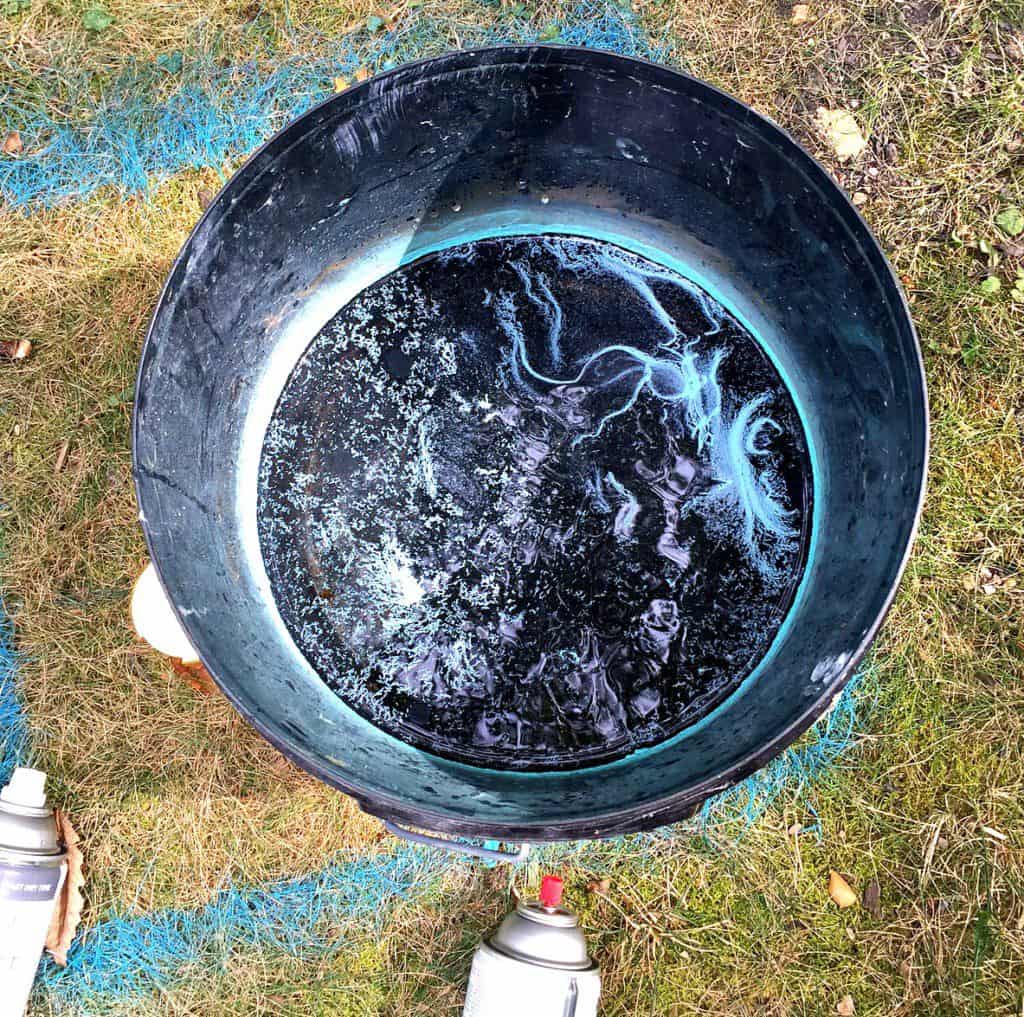 spray paint into bucket of water