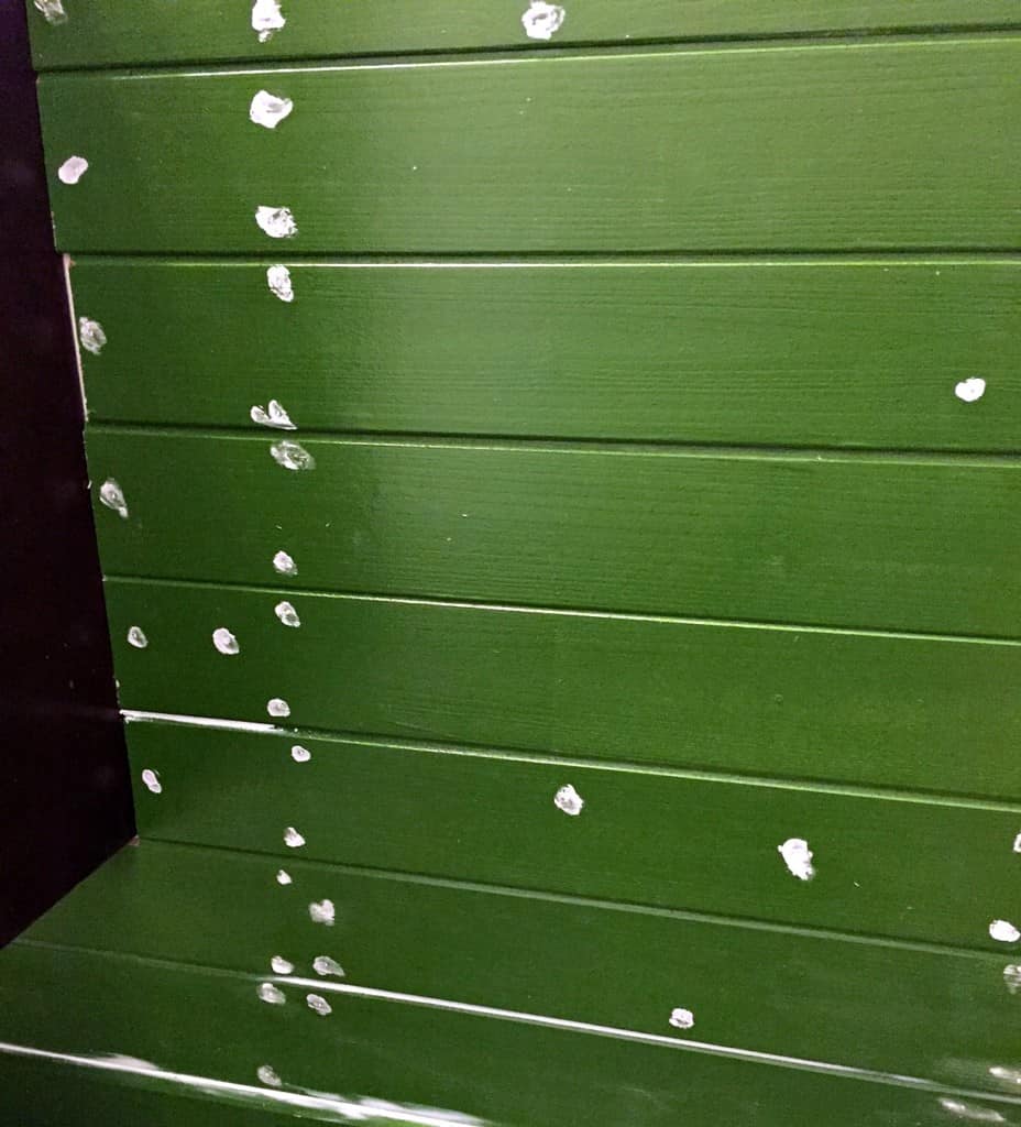 green painted shiplap with nail filler