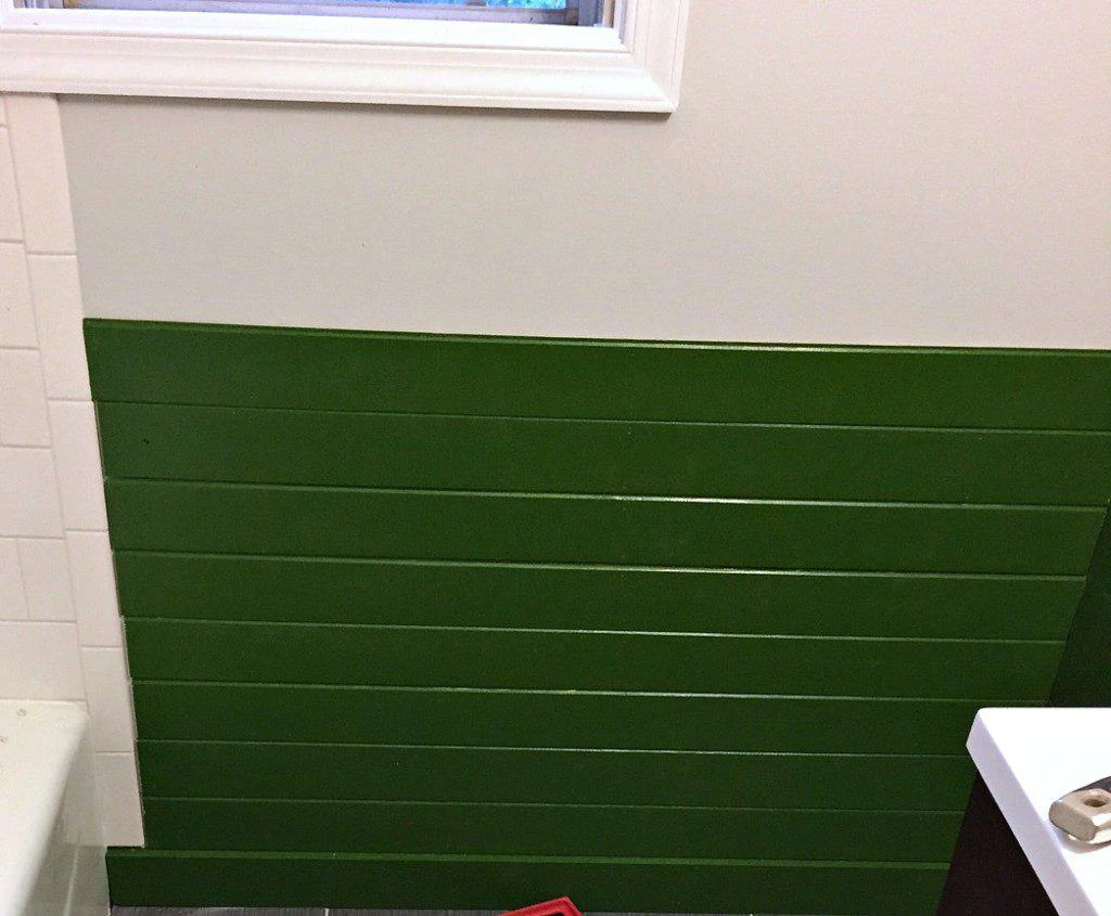 green shiplap walls in bathroom