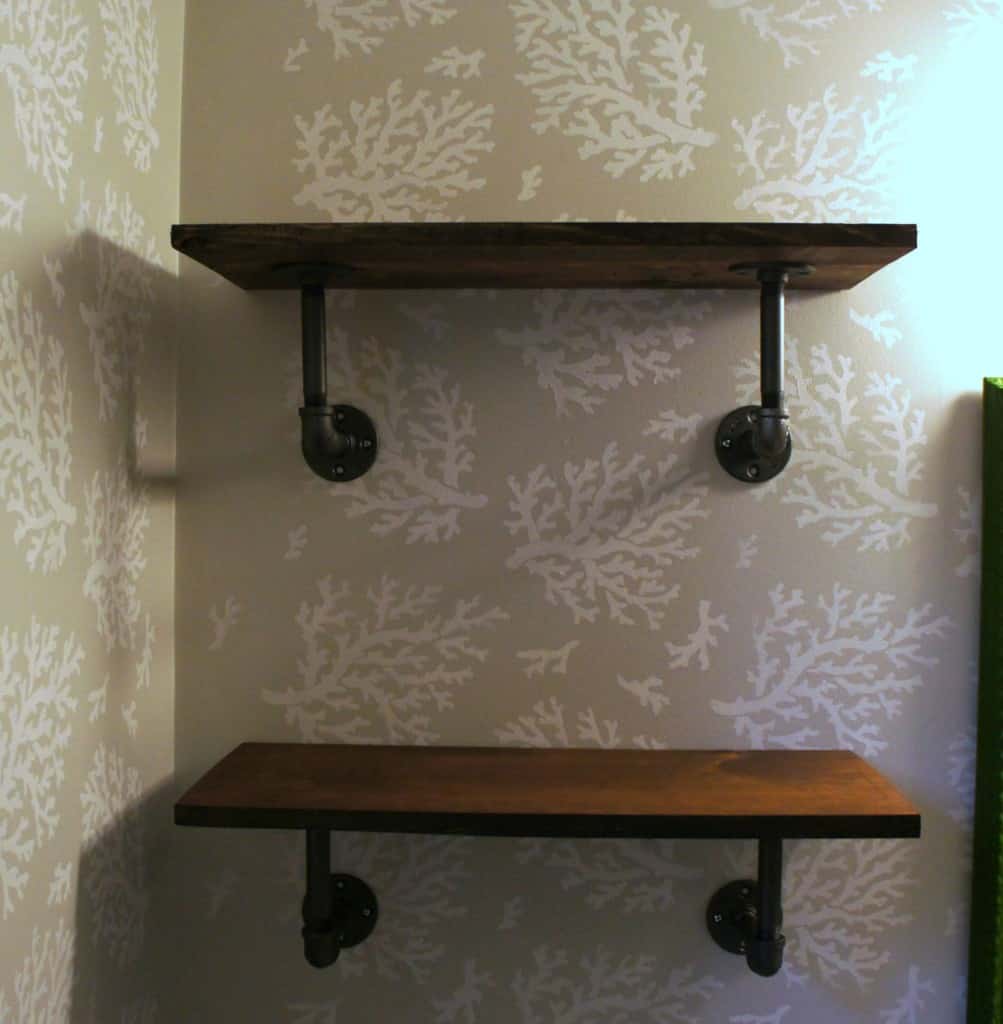 pipe shelves on stenciled wall