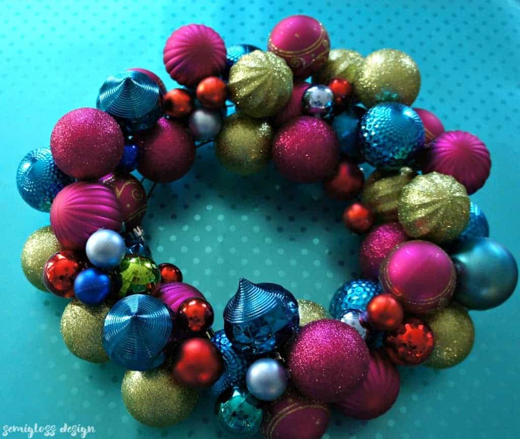 A DIY ornament wreath is a fun way to add color to your holiday decor. Make one today! #christmasdecor #christmasdecorations #christmaswreaths #ornamentwreath