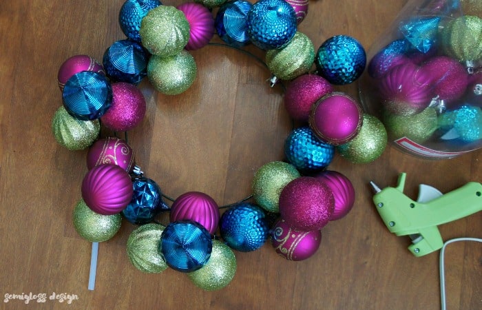 A DIY ornament wreath is a fun way to add color to your holiday decor. Make one today! #christmasdecor #christmasdecorations #christmaswreaths #ornamentwreath