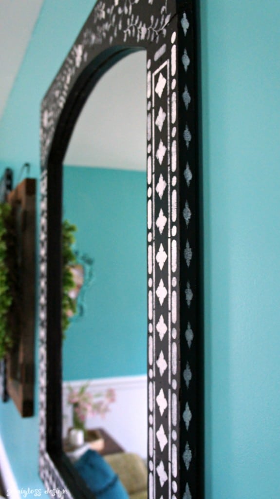 Learn how to use an Indian inlay stencil for a mirror makeover! This easy DIY makeover is a great way to add a boho touch to your home!