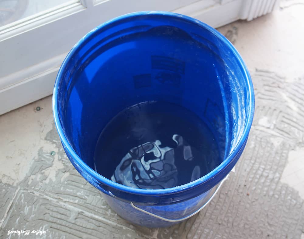 water in bucket to mix concrete