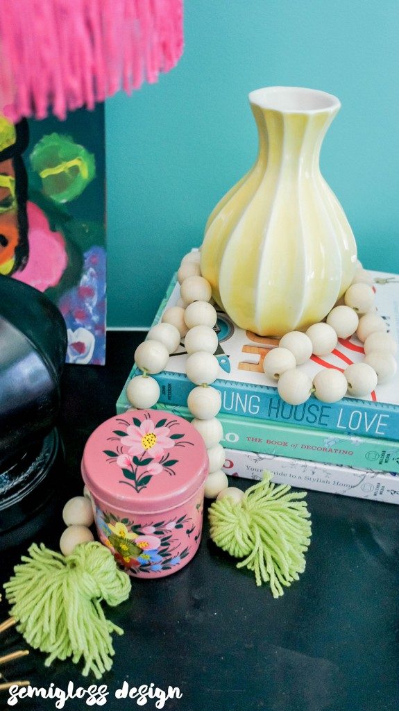 stack of books, vase and beads