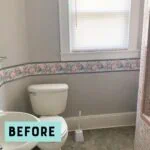before picture of bathroom with gray wallpaper and floral wallpaper border
