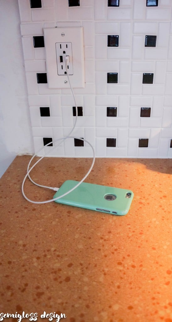 installed USB outlet charging a phone