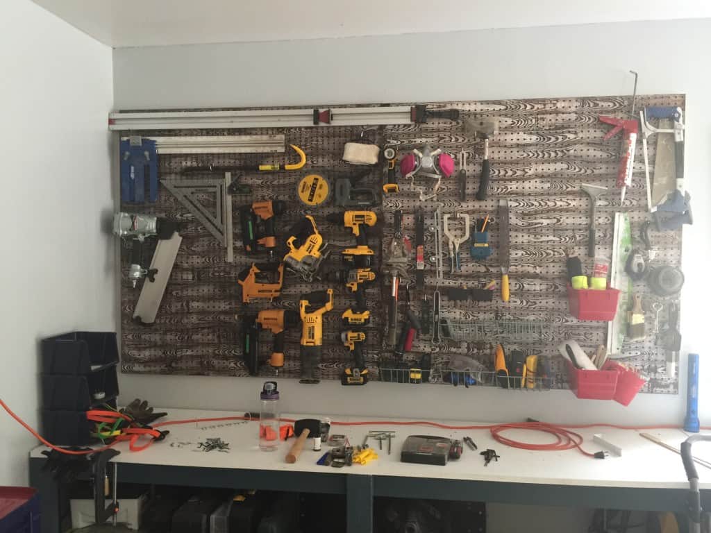 wood grain pegboard installed in garage with tools