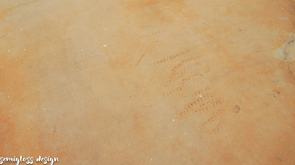 rust spots on stained concrete floor