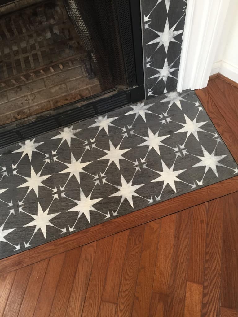 Stenciled fireplace tile surround