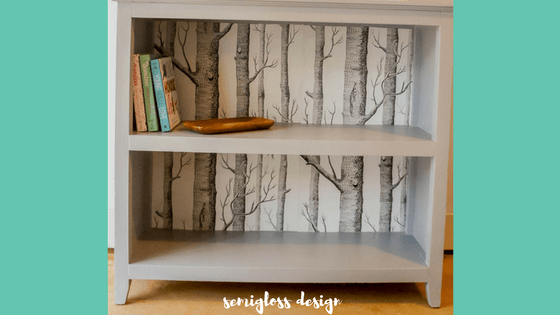 A bookshelf makeover with paint and leftover wallpaper. Make that boring bookshelf amazing!