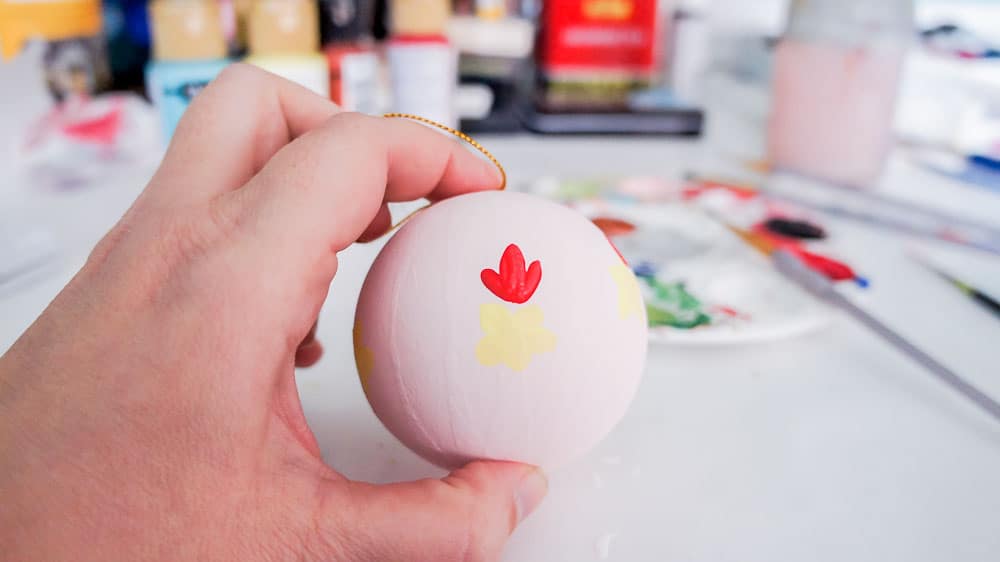 Make your own hand painted floral ornaments. This easy technique works for non-artists too. #decoartprojects #christmasornaments #diychristmasdecor #handpaintedflorals