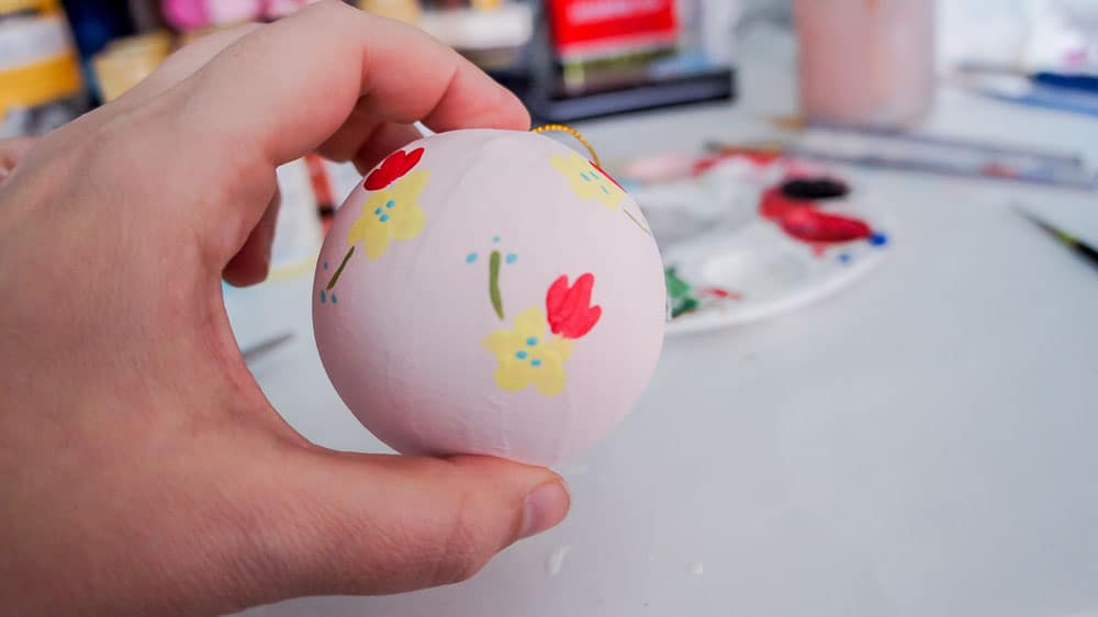 Make your own hand painted floral ornaments. This easy technique works for non-artists too. #decoartprojects #christmasornaments #diychristmasdecor #handpaintedflorals