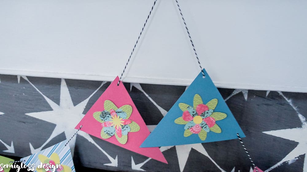 Make your own paper flower banner for spring. This fun DIY spring decor project is simple and budget friendly. Free flower cut files. #cutfile #papercrafting #banner #springdecor