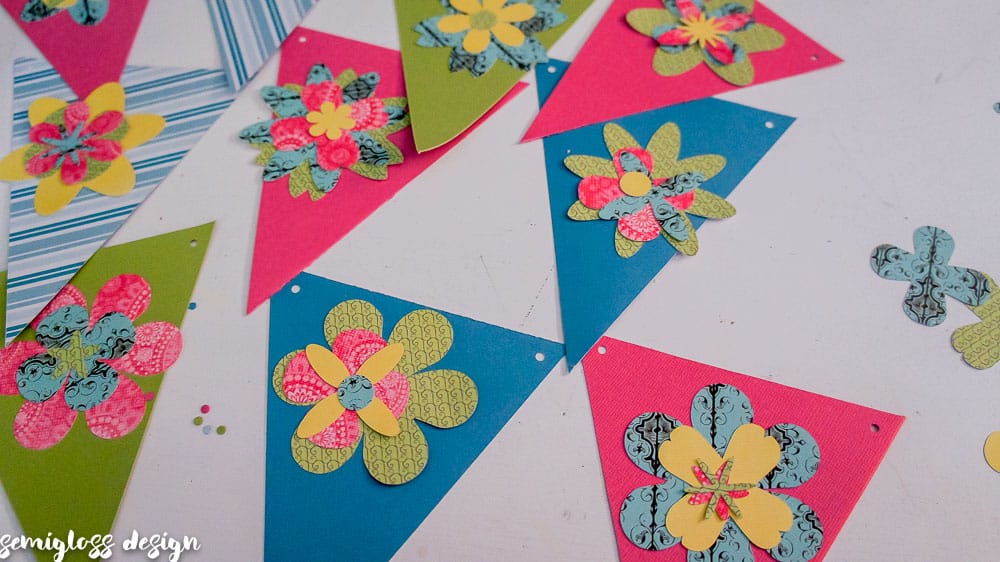 Make your own paper flower banner for spring. This fun DIY spring decor project is simple and budget friendly. Free flower cut files. #cutfile #papercrafting #banner #springdecor