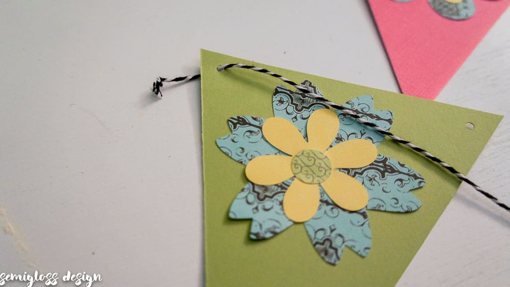 Make your own paper flower banner for spring. This fun DIY spring decor project is simple and budget friendly. Free flower cut files. #cutfile #papercrafting #banner #springdecor