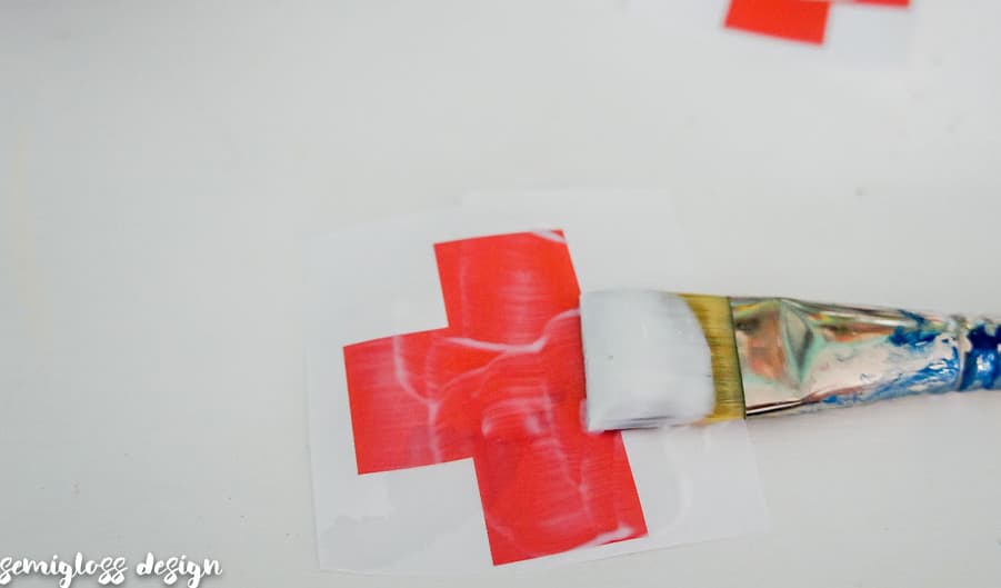 Paint red cross with glue