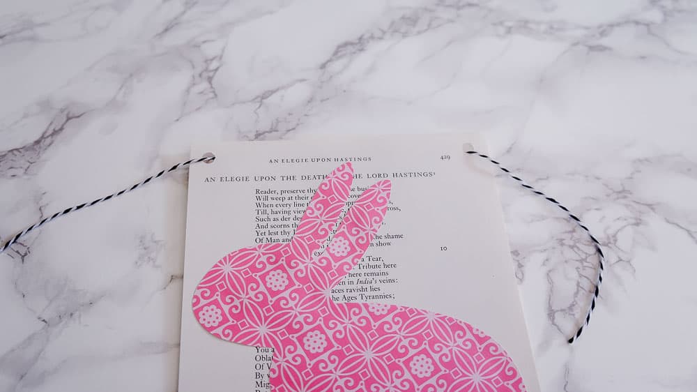 Need an easy spring project? This DIY Easter banner is made with scrapbook paper and old book pages. It's an easy craft to bring in some spring color. #eastercrafts #easterbunny #cutfiles #papercrafting