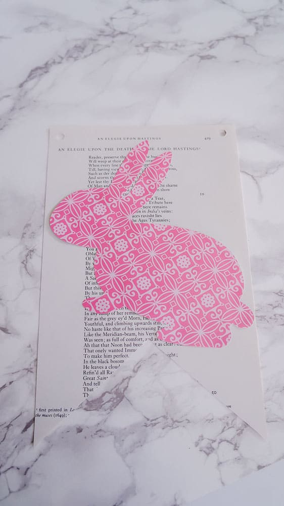 Need an easy spring project? This DIY Easter banner is made with scrapbook paper and old book pages. It's an easy craft to bring in some spring color. #eastercrafts #easterbunny #cutfiles #papercrafting