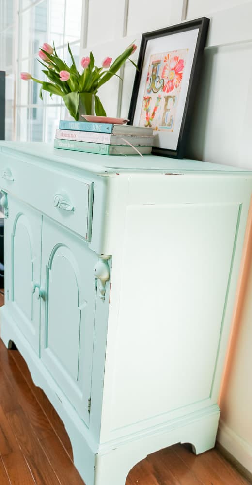 A spring furniture makeover featuring a pastel aqua paint on a credenza. This piece went from stuffy to gorgeous! #painted furniture #fusionmineralpaint #springdecor