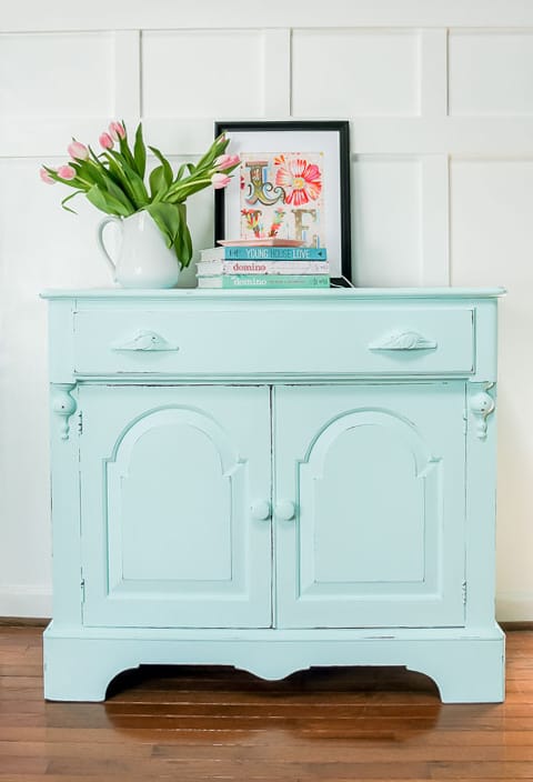 A spring furniture makeover featuring a pastel aqua paint on a credenza. This piece went from stuffy to gorgeous! #painted furniture #fusionmineralpaint #springdecor