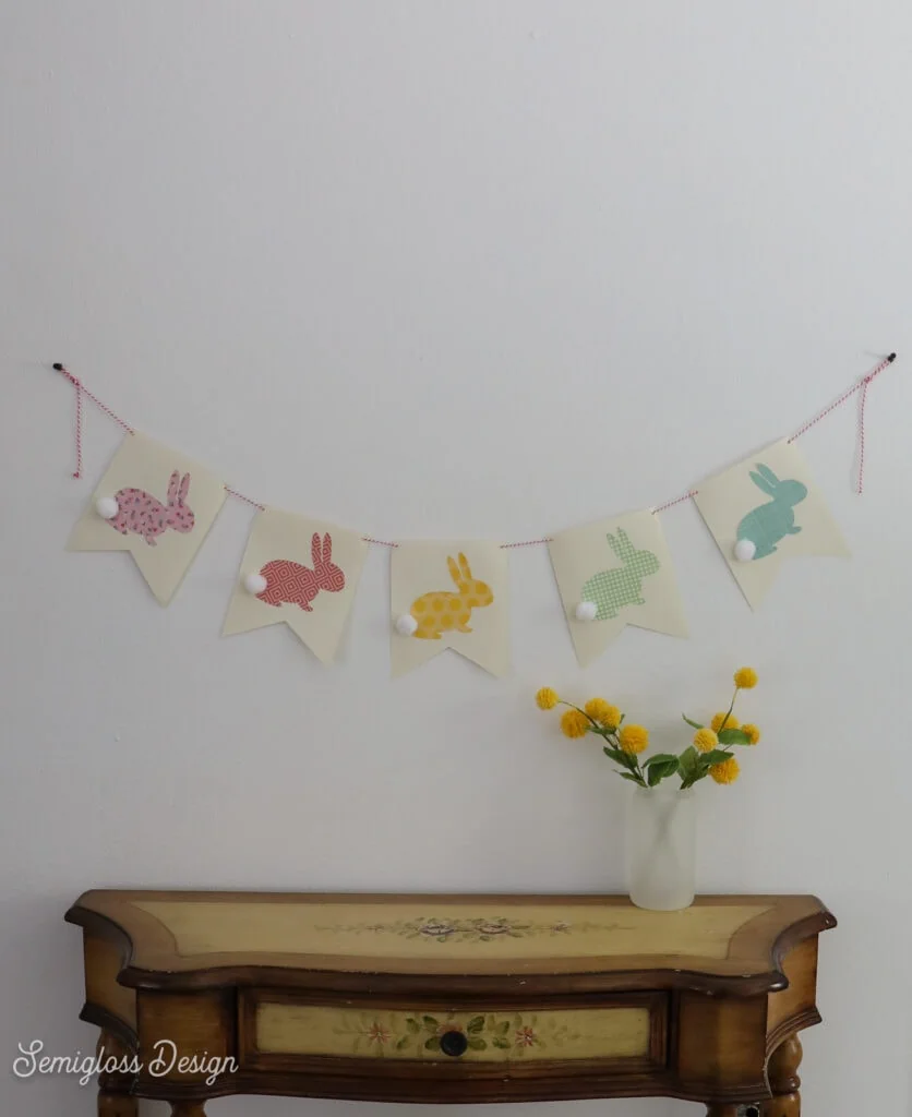 bunny garland over table with vase of flowers