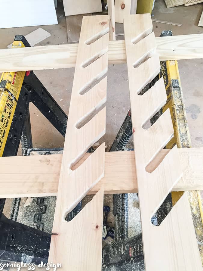 Use a jig saw to cut slats using wood holes as guide.