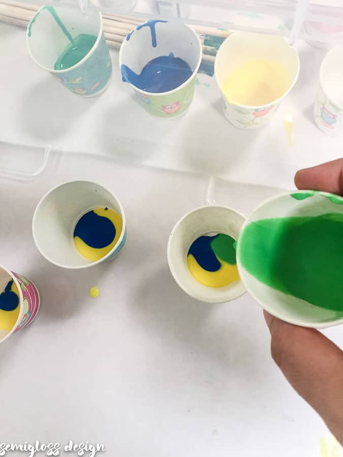 pour paint slowly into cups