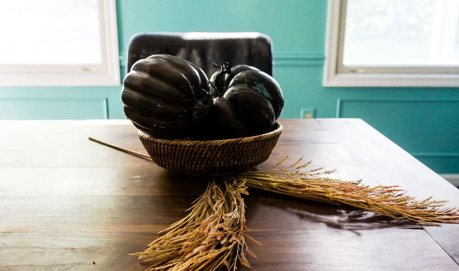 painted metallic pumpkins in wicker bowl