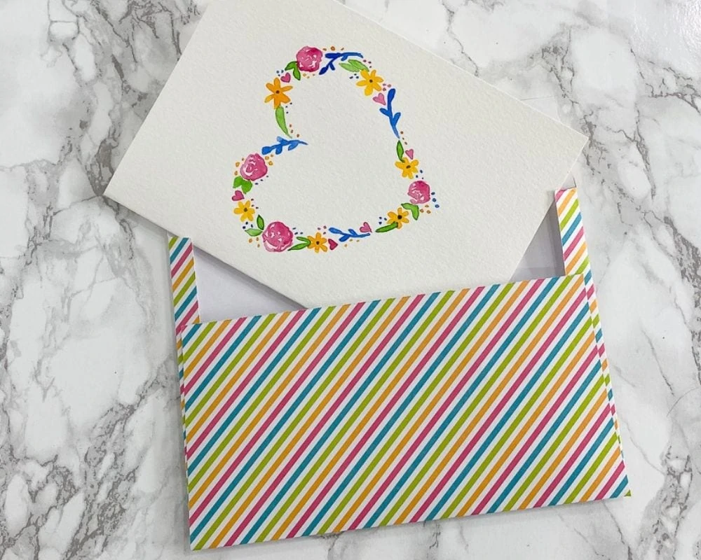 rainbow striped envelope with floral heart card