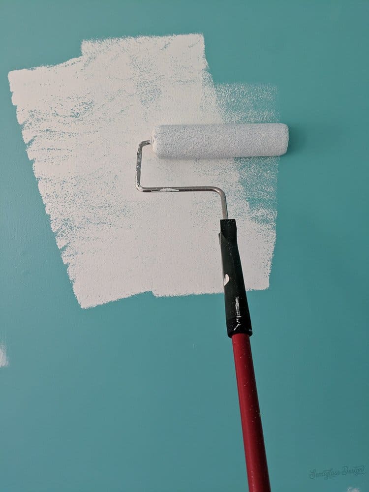 painting white on teal wall