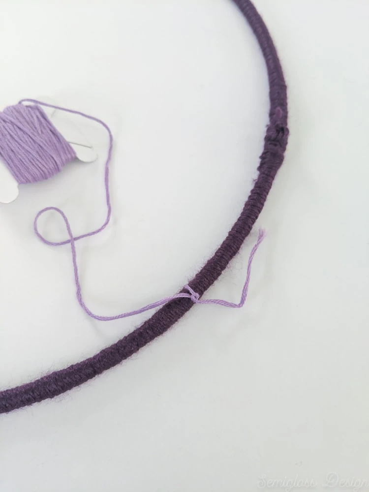 tying on embroidery floss to yarn wrapped ring