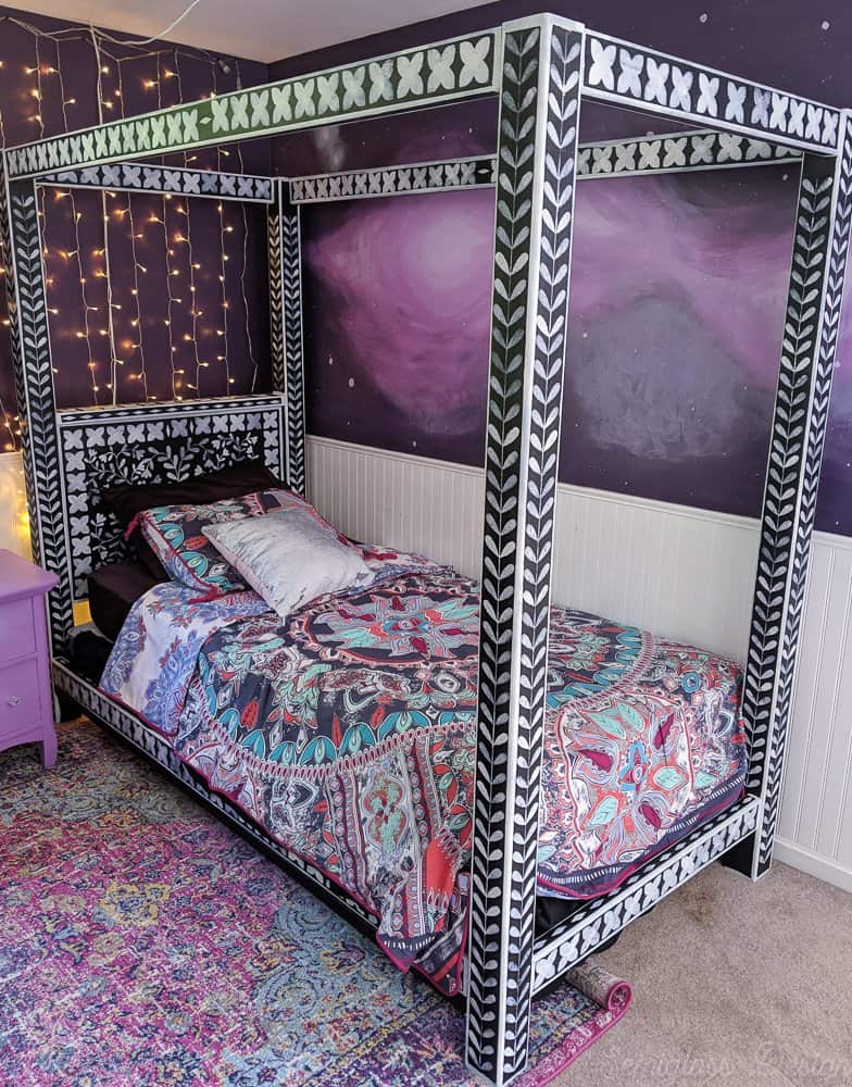 bone inlay stenciled canopy bed in boho bedroom