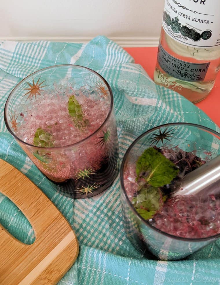 Add club soda to muddled fruit