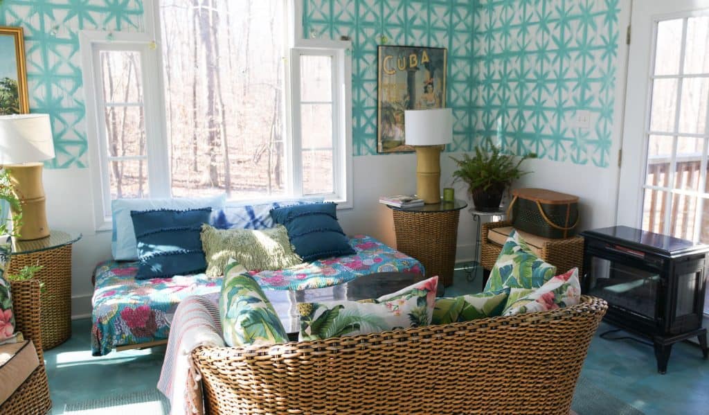 boho sunroom with teal shibori walls and wicker furniture