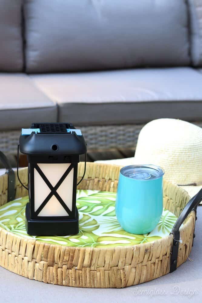 patio table with wine tumbler and lantern