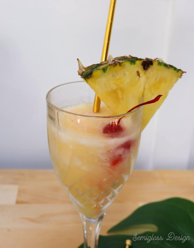 pina colada garnished with pineapple slice and cherry