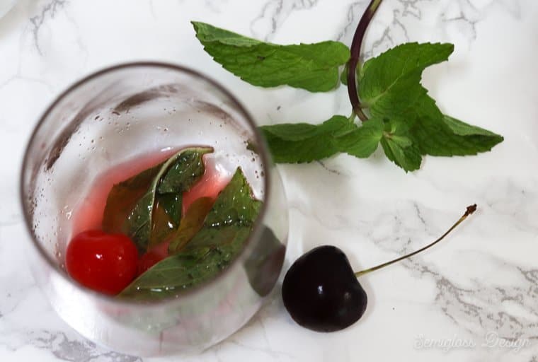 muddling a cherry mojito