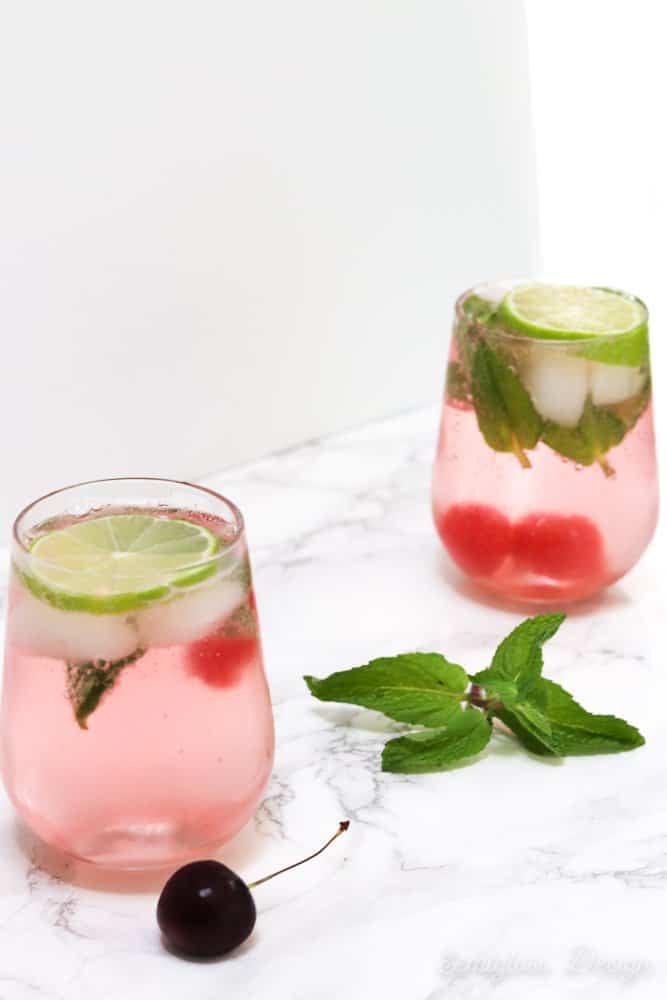 cherry mojitos in glasses with limes