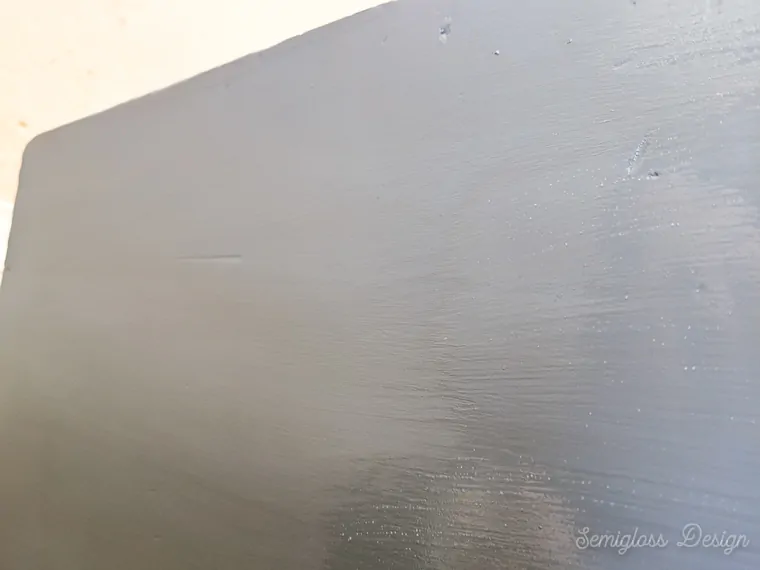 brushing long streaks of polycrylic on dresser