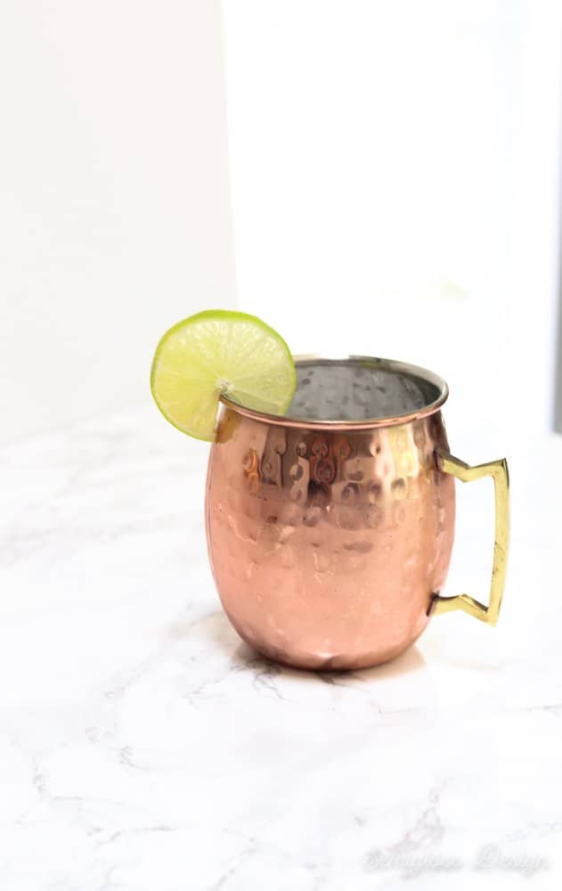 copper mug filled with moscow mule with lime garnish