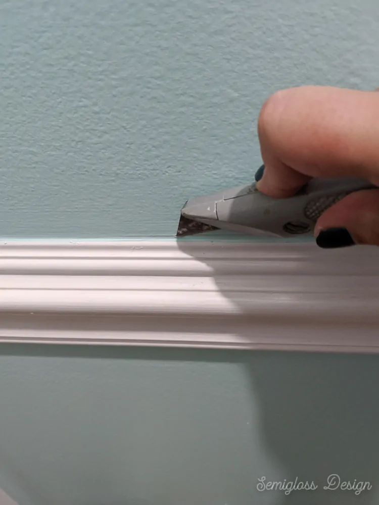 using utility knife to score caulk