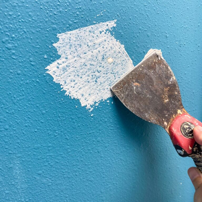 patching nail holes on blue wall