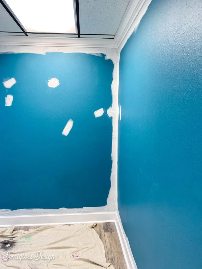 primed repair spots on blue wall