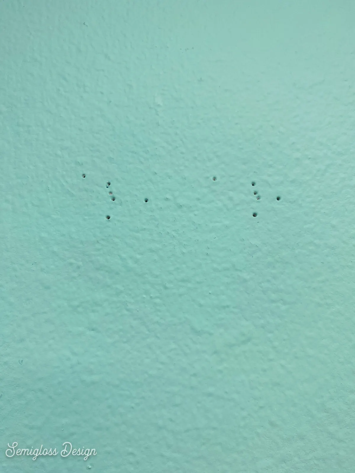 tiny nail holes on aqua wall