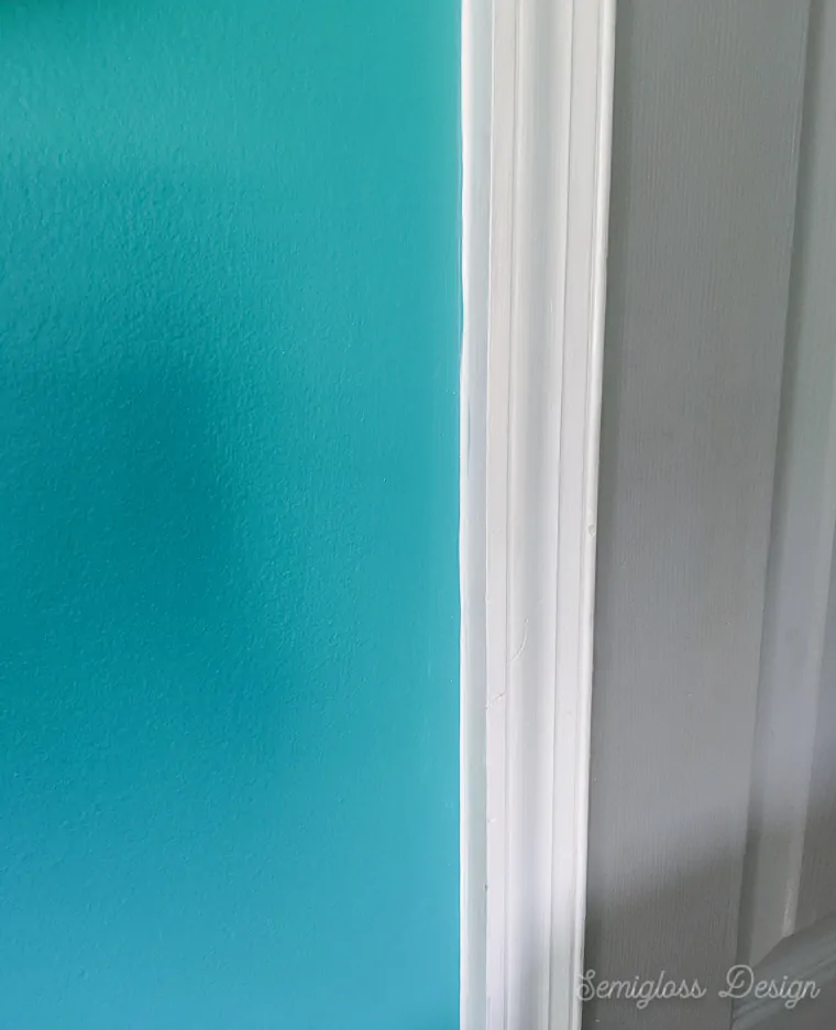 white painted trim against teal walls