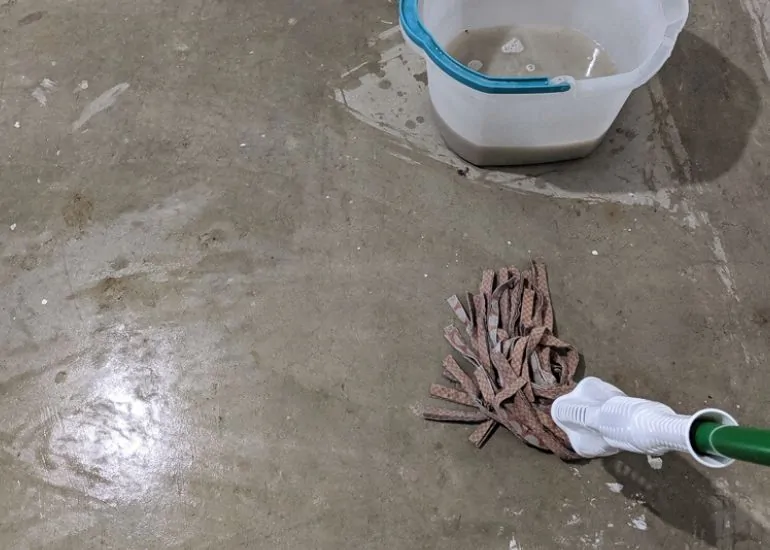 mopping floor to clean paint overspray