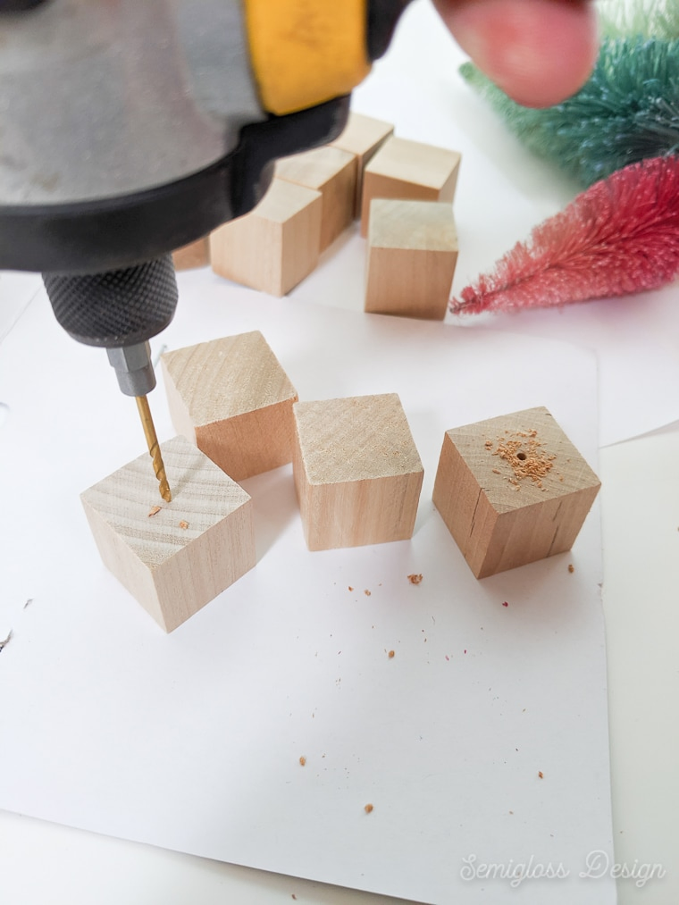 drilling holes in wooden blocks for bottle brush tree bases